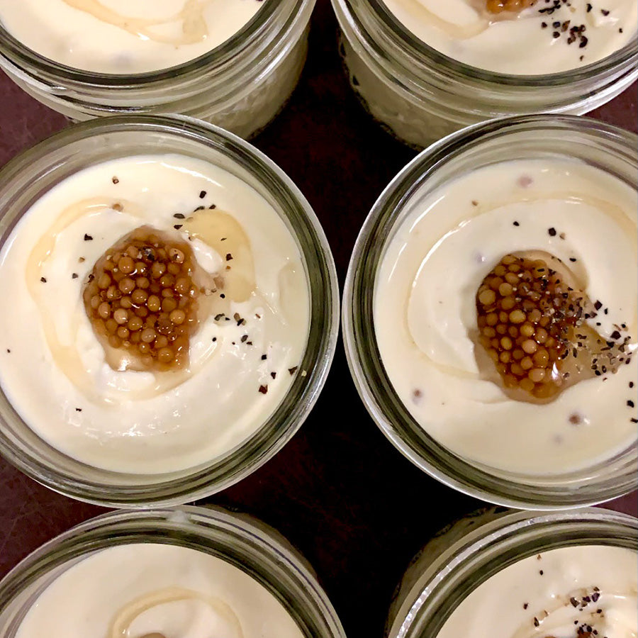 Jars of beer cheese with mustard seeds 